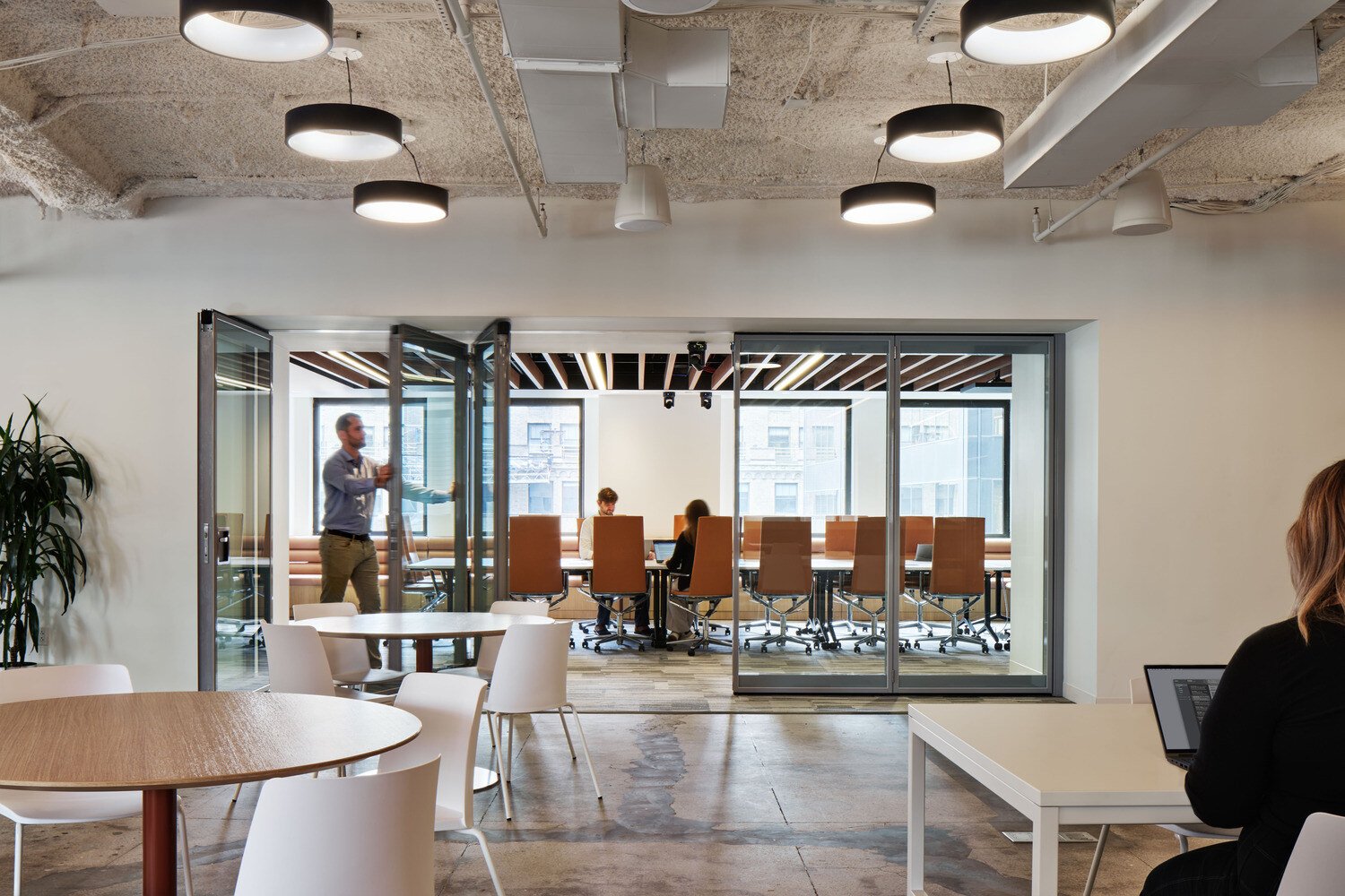flexible workplace with a meeting room and small tables