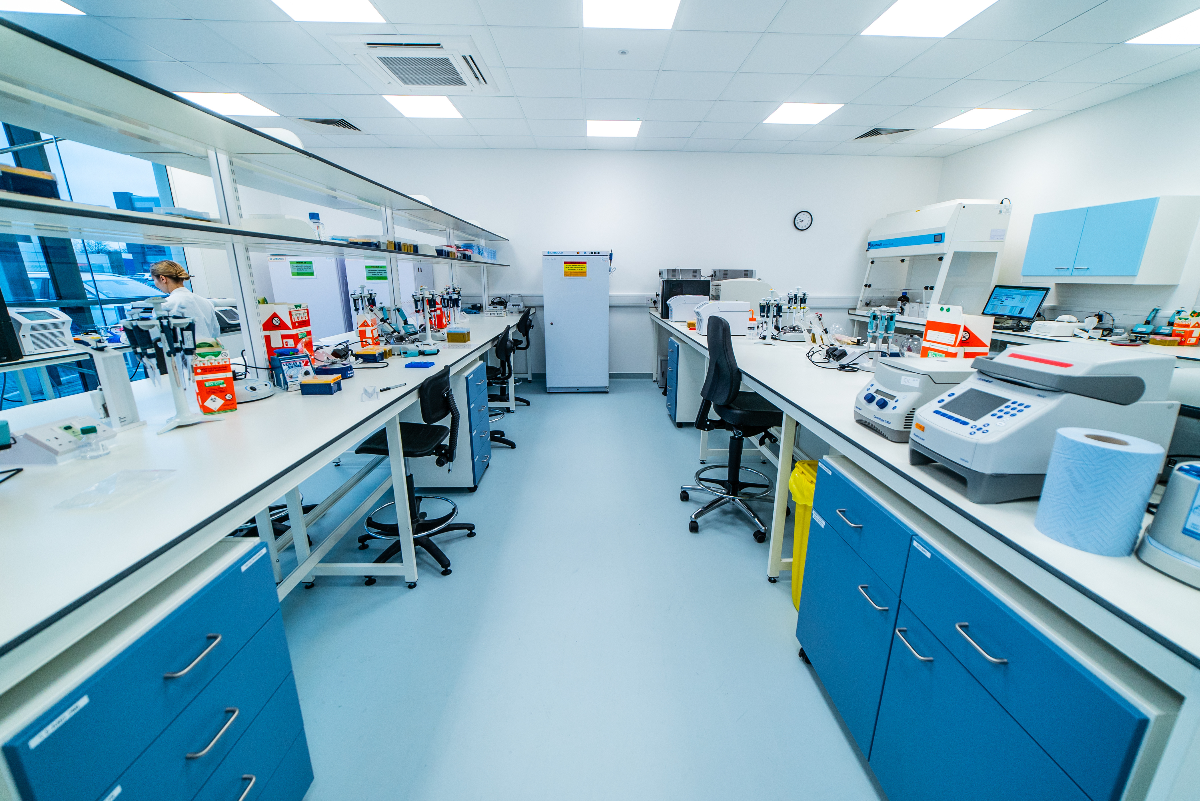 Oxford Gene Technology (OGT) labs were collaboratively designed with users to optimize processes, featuring built-in storage, large inter-lab windows, and internal transfer hatches.